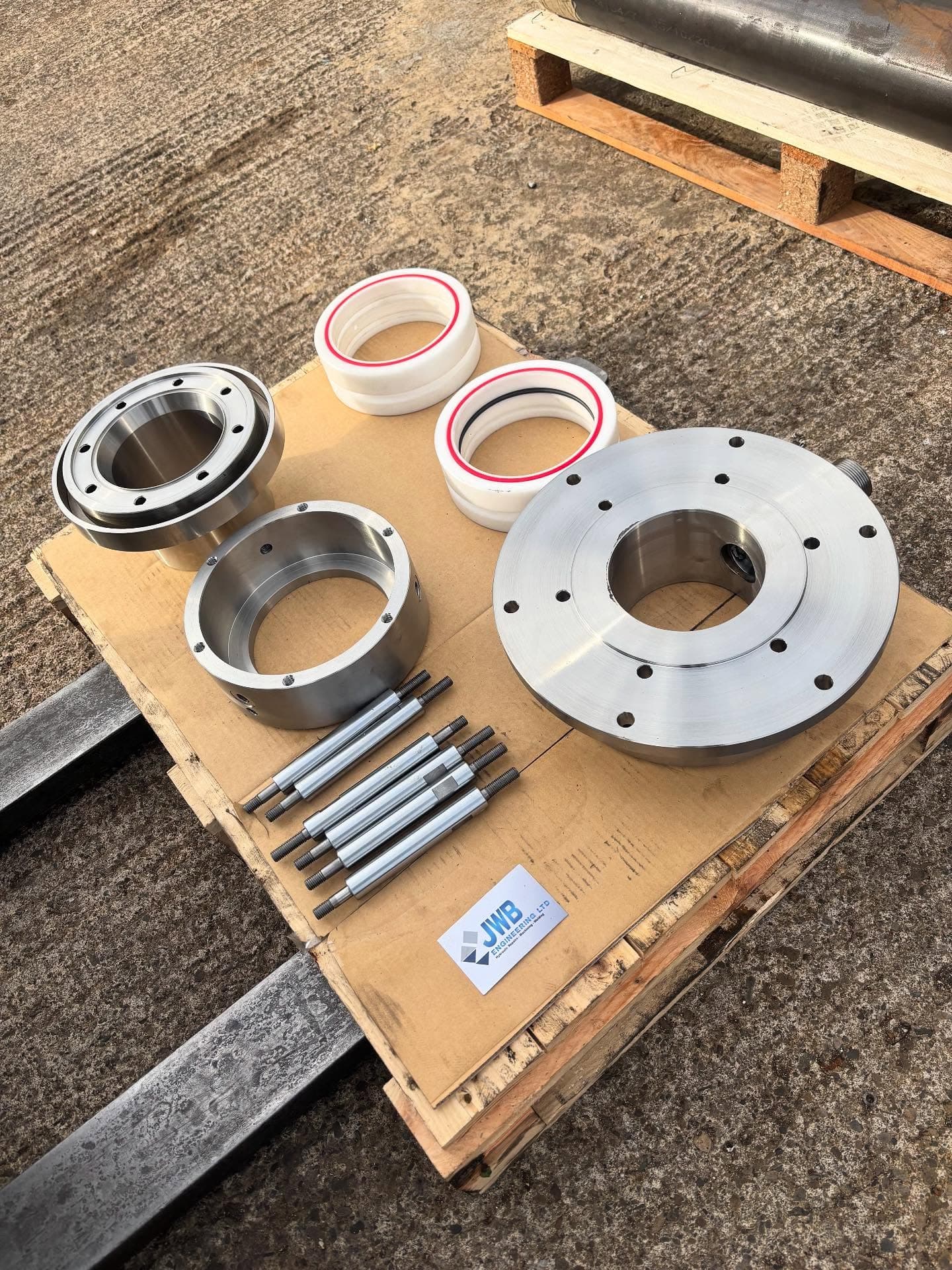 Machined hydraulic cylinder rebuild components including glands, bearing housing and nylon seal carriers