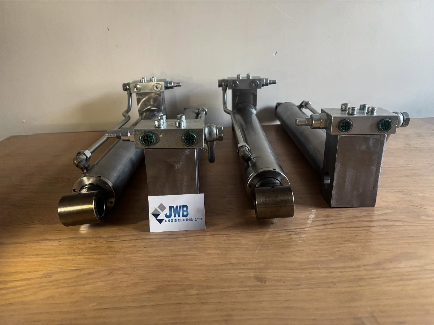 Rebuilt stainless hydraulic cylinders with welded manifold blocks and bronze bushed rod eyes